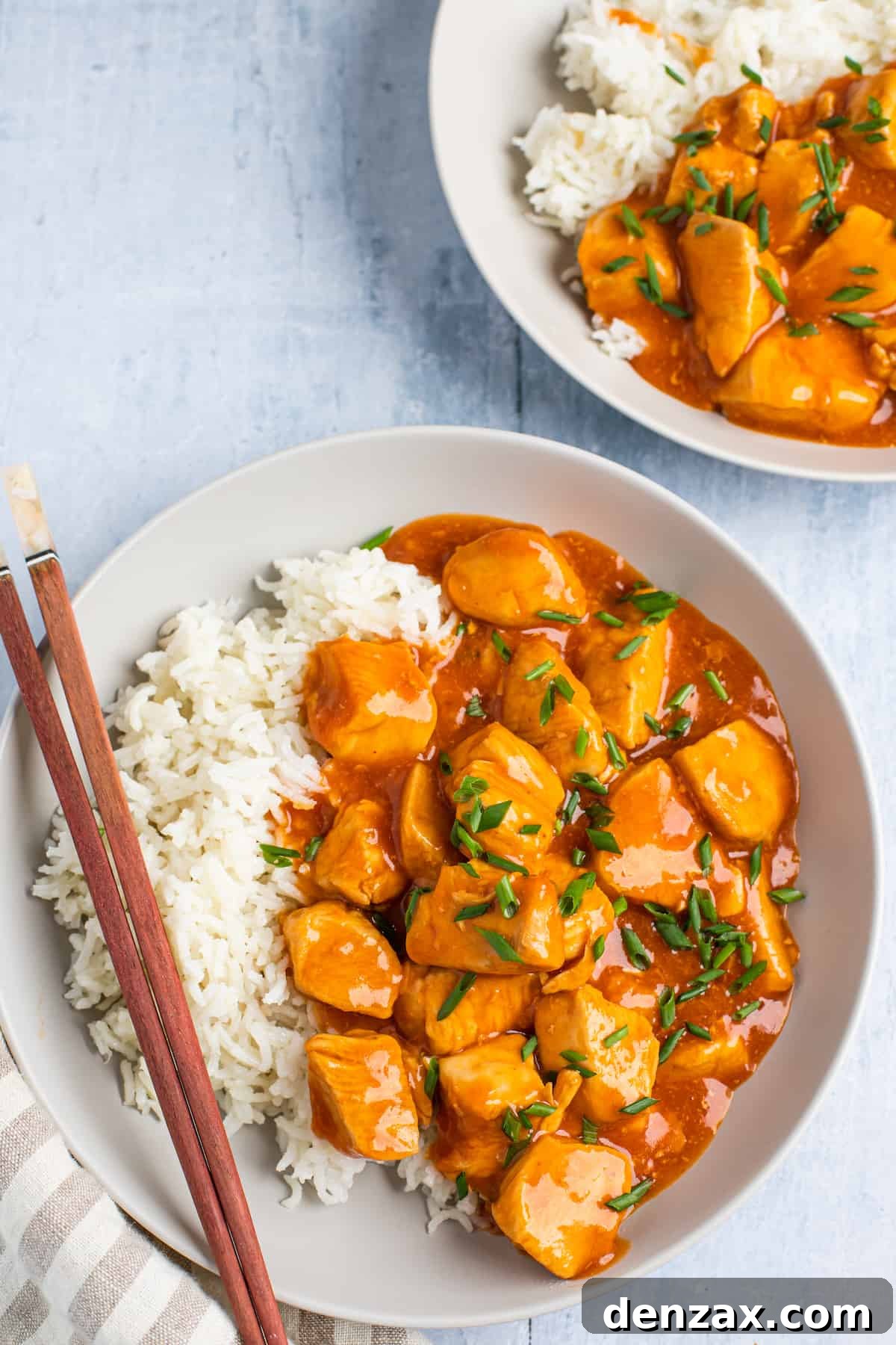 Instant Pot Orange Chicken Recipe: Sticky, Tangy Weeknight Meal 9 Two plates with servings of orange chicken and rice.