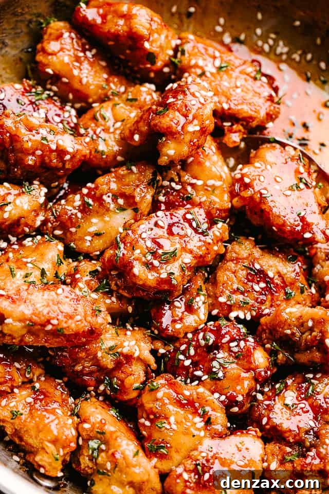 Crispy Honey Sesame Chicken garnished with sesame seeds and served on a plate