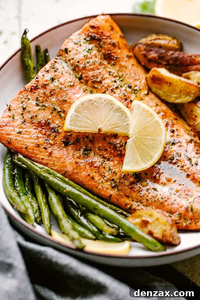 This easy broiled salmon recipe is the tasty dinner you’ve been looking for! Lightly crisp on the outside but tender and juicy on the inside. Broiled salmon plated with potatoes and greenbeans and garnished with lemon wedges