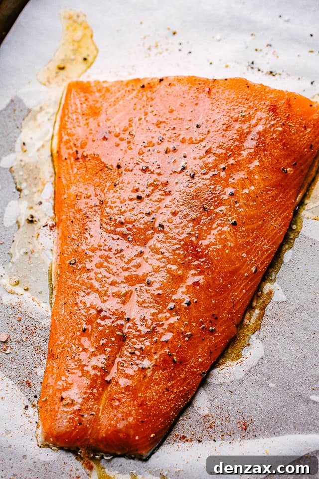 This easy broiled salmon recipe is the tasty dinner you’ve been looking for! Lightly crisp on the outside but tender and juicy on the inside. raw salmon topped with olive oil and black pepper