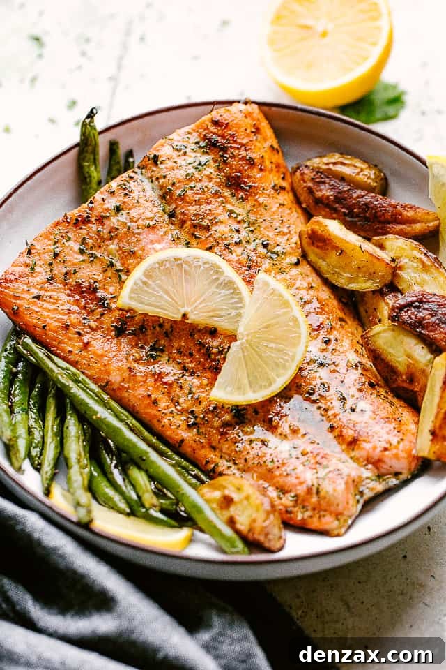 This easy broiled salmon recipe is the tasty dinner you’ve been looking for! Lightly crisp on the outside but tender and juicy on the inside. Broiled salmon plated with potatoes and greenbeans and garnished with lemon wedges