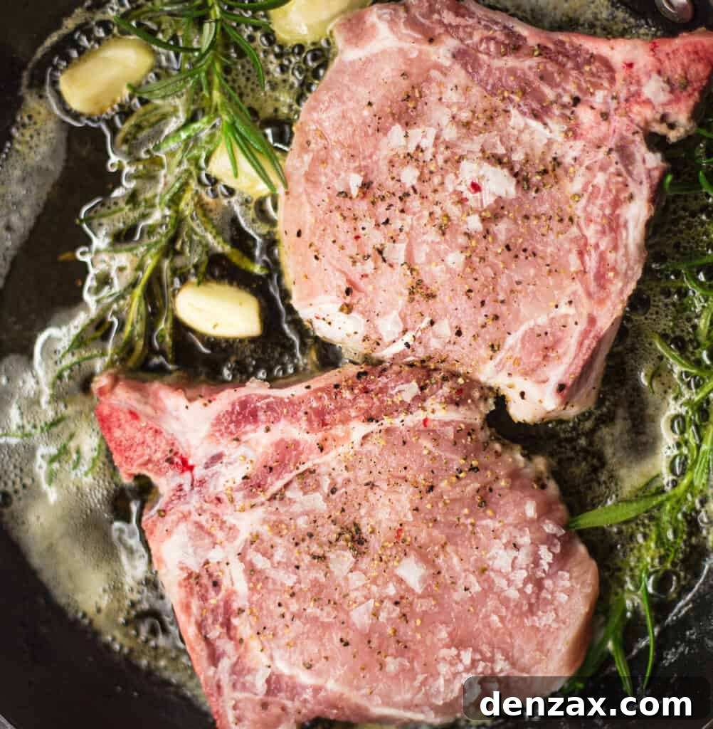 Roasted Pork Chops with Apples and Winter Vegetables 4 Searing pork chops in a skillet with garlic and rosemary.