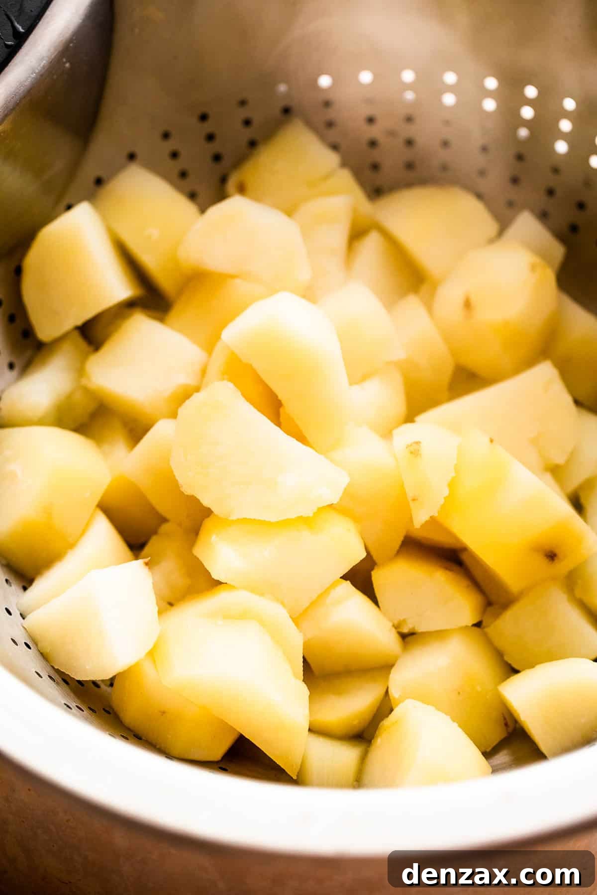 cooked diced potatoes in a collander