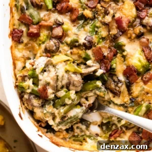 spooning out green bean casserole from a white baking dish.