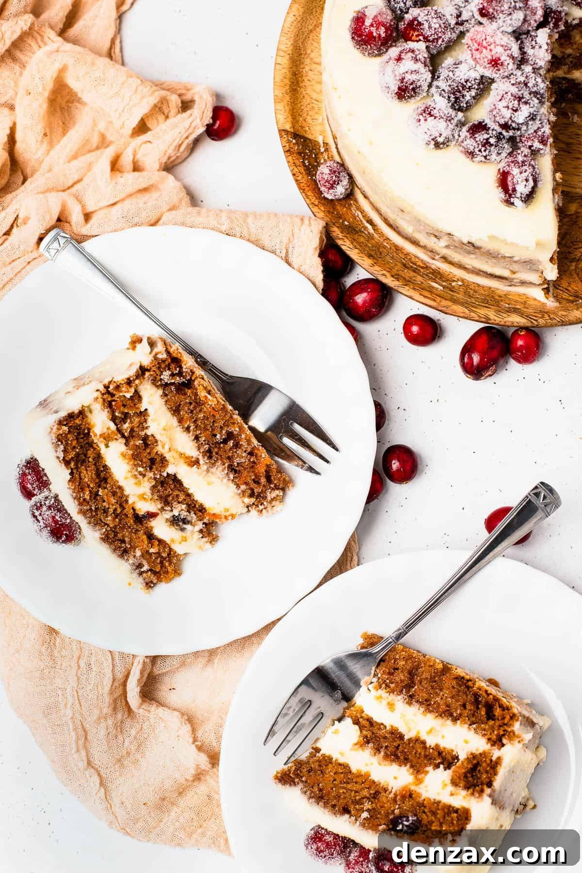 Carrot Cake with Sugared Cranberries: Moist Spring Dessert 7 Slices of sugared cranberry layer cake on dessert plates, next to the remaining cake on a cake stand.