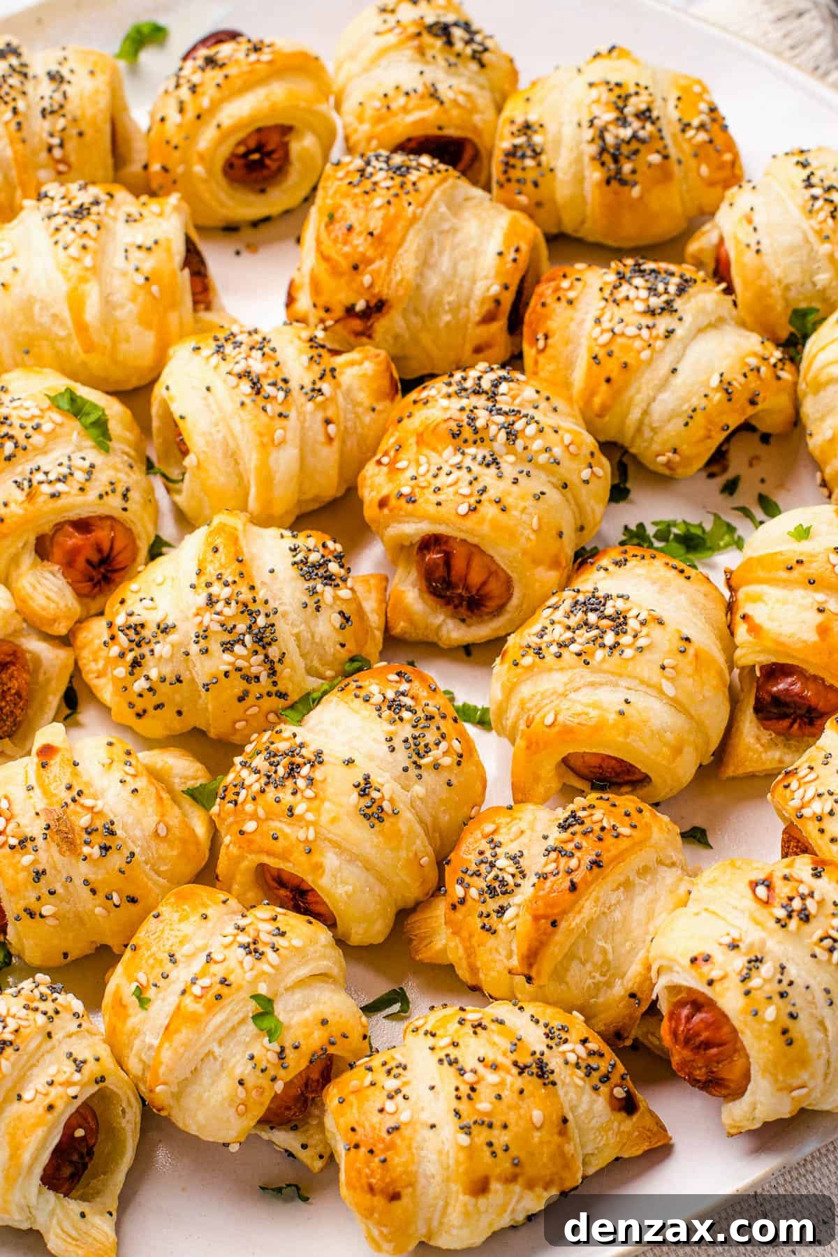 Close up shot of crescent roll hot dogs sprinkled with sesame and poppy seeds.