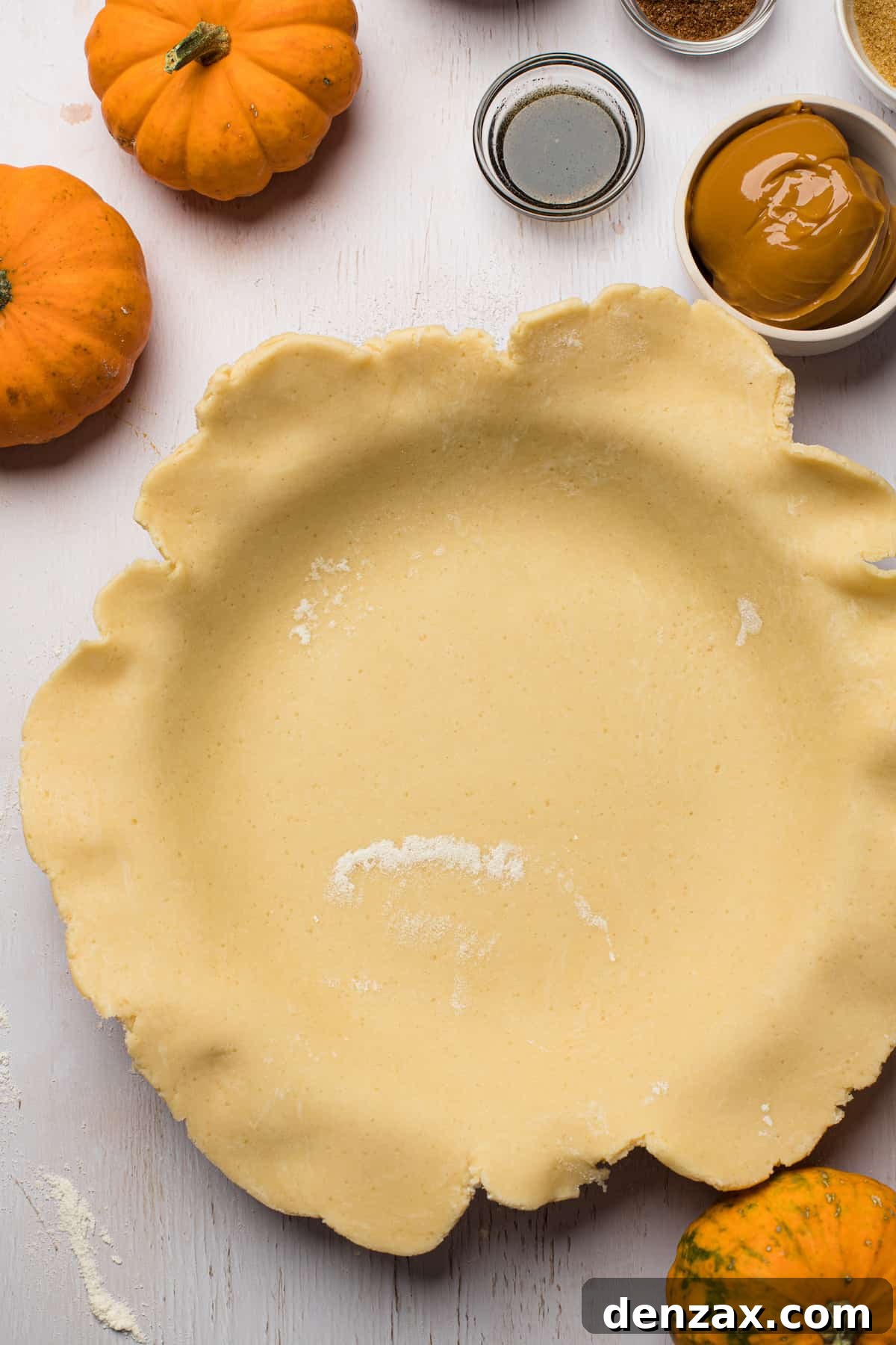 This homemade and easy Pumpkin Pie recipe is a holiday favorite! Everyone will love the tender pie crust, warm spices, and dulce de leche pumpkin filling. A pie plate lined with homemade pie crust that has not yet been trimmed to fit.