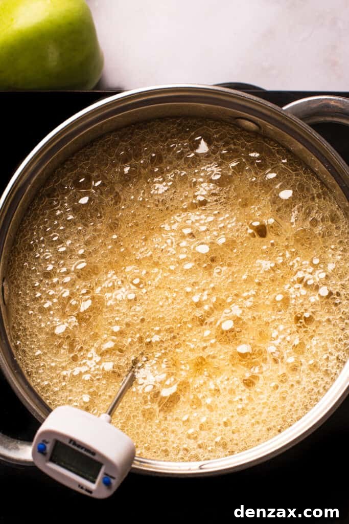 A saucepan of boiling undyed sugar candy mixture.