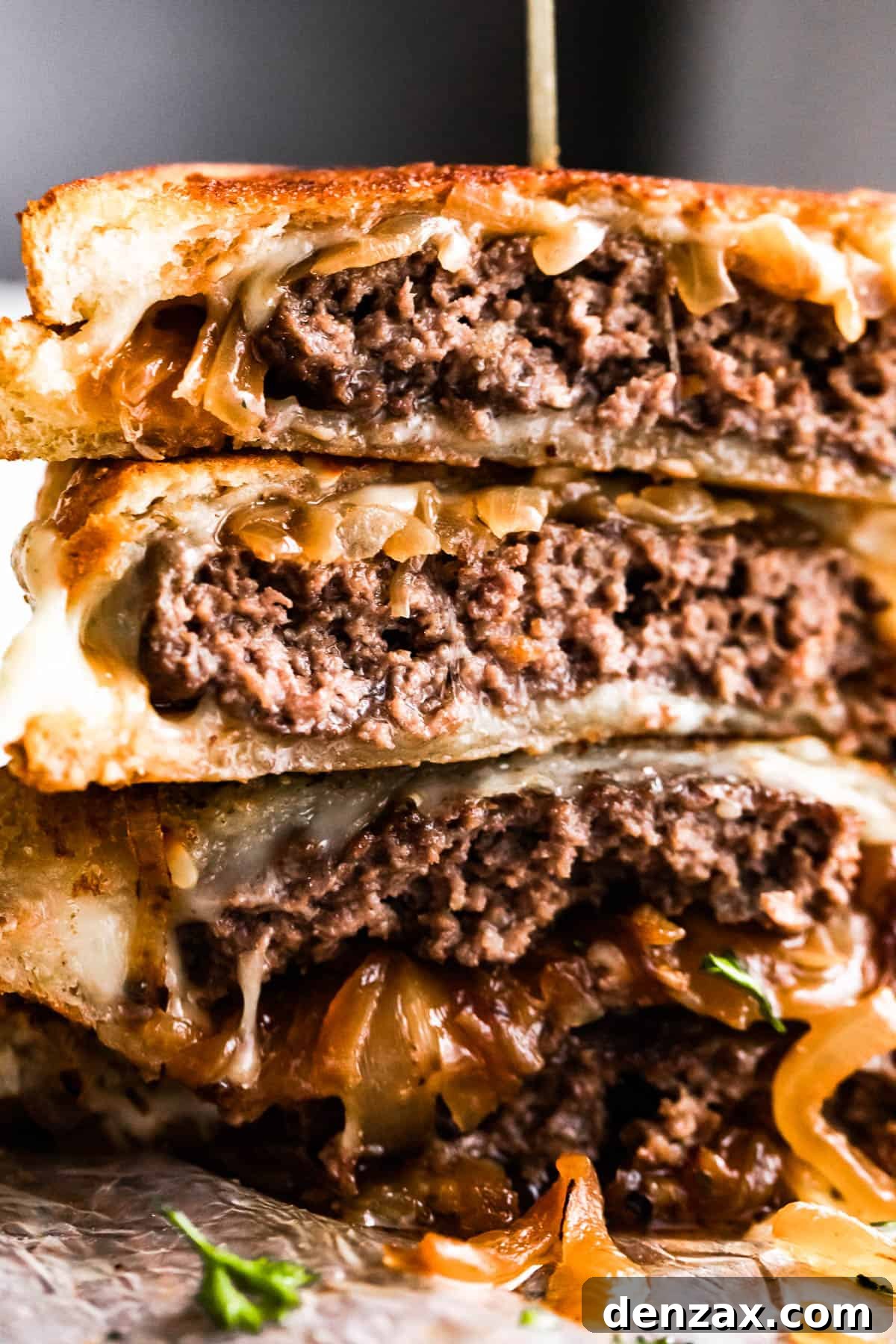 up close shot of cut into and stacked up patty melt sandwich.